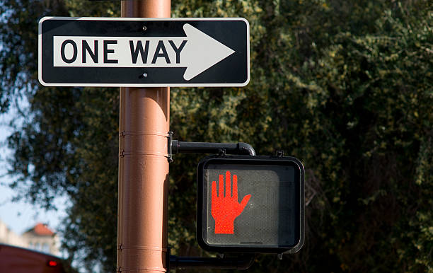 placa de um caminho no centro da esquina não atravessar - one way stop stop sign street - fotografias e filmes do acervo