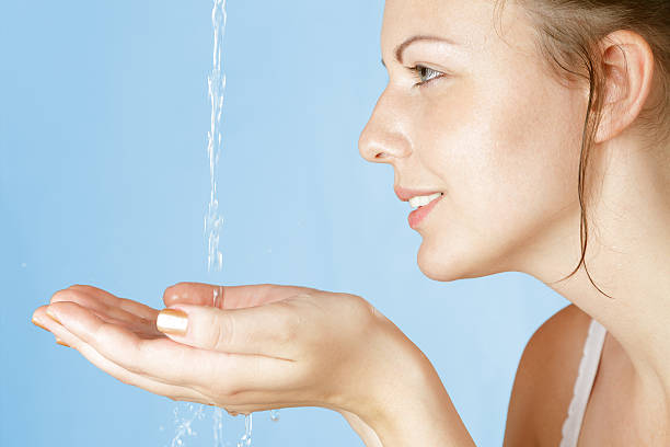 istock Water pouring into woman's open cupped hands 153896657