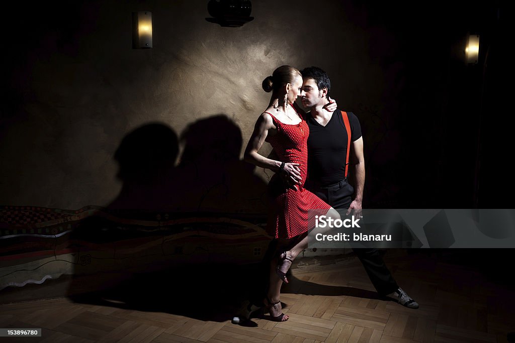 Let's Tango! A man and a woman in the most romantic dance: tango. A nice kissing couple shadow light effect on the wall. Please check similar images from my portfolio. Adult Stock Photo
