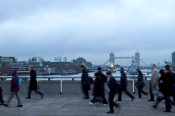 istock city workers walking to work across London Bridge 153896952