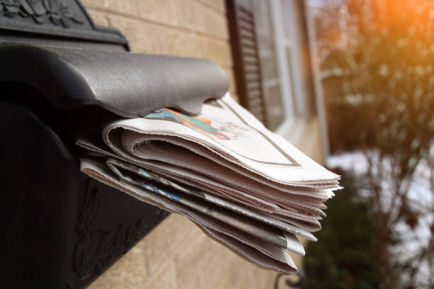 istock Piles  of newspapers in a  mail box outside. 1538971350