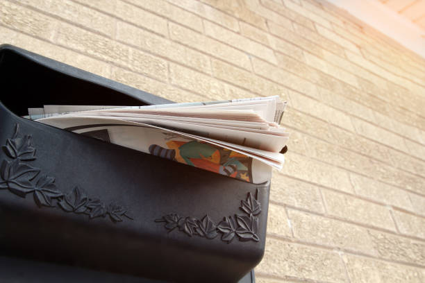 istock Piles  of newspapers in a  mail box outside. 1538971380