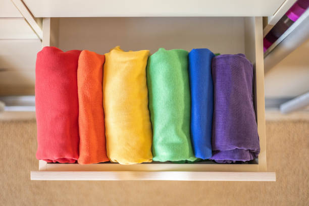 istock Multi-colored clothes folded vertically in a wardrobe drawer. The concept of order and storage 1538974531