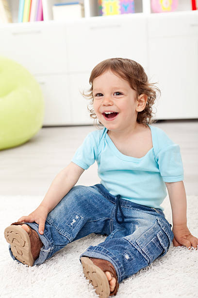 istock Happy toddler boy sitting on the floor 153898525