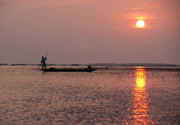 istock silhouette fisherman on boat 153899888