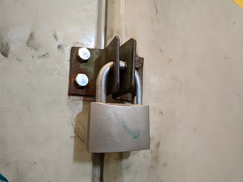 A vault locked with a silver padlock