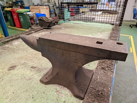 An anvil on a workbench in a workshop
