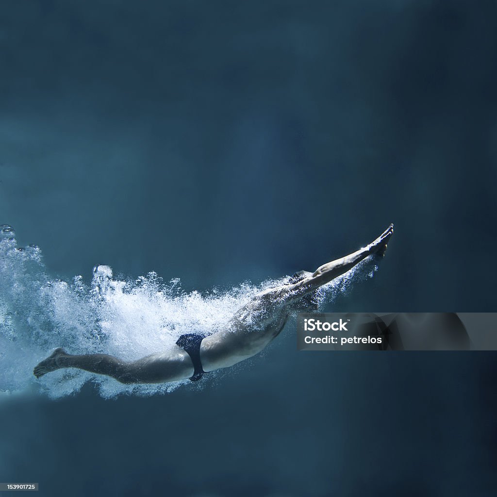 professional swimmer underwater after the jump Diving Into Water Stock Photo