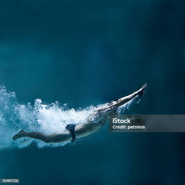 Professional Swimmer Underwater After The Jump Stock Photo - Download Image Now - Diving Into Water, Swimming, Underwater