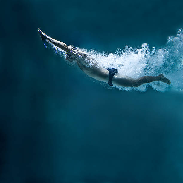 istock professional swimmer underwater after the jump 153902331