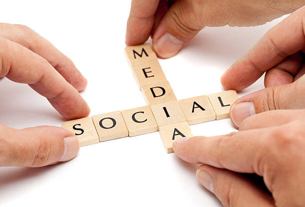 Hands forming the term "social media" from letters