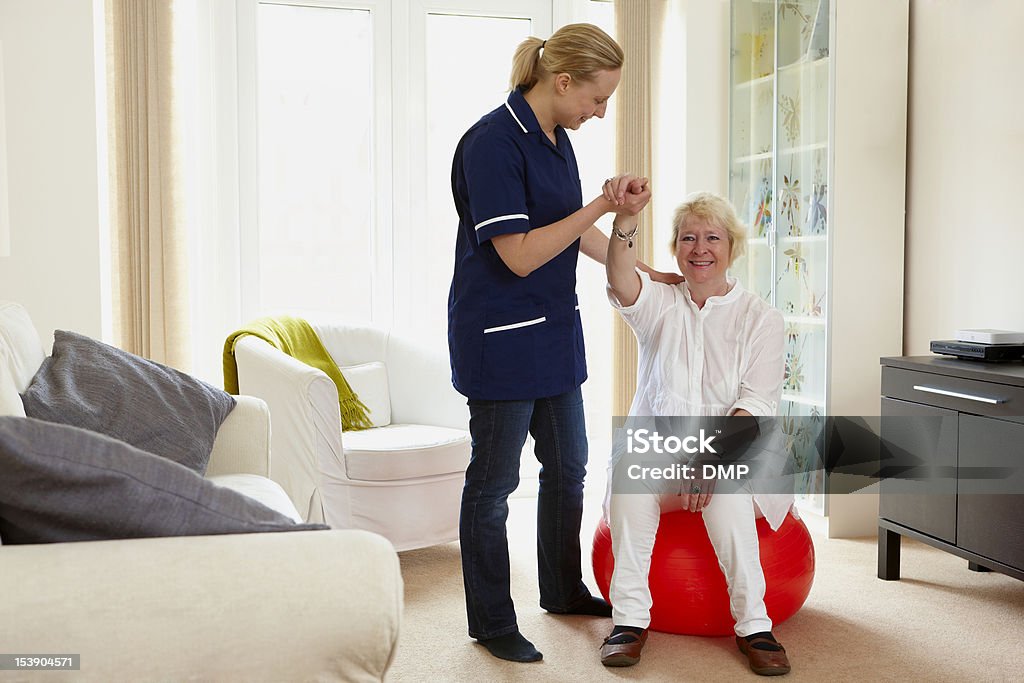 Enfermera ayudando a senior mujer con su rehabilitación ejercicios - Foto de stock de Actividades y técnicas de relajación libre de derechos