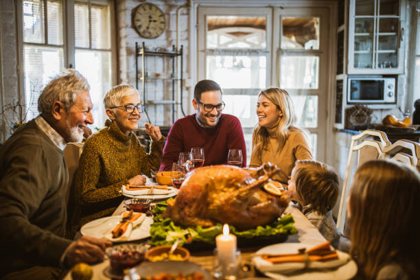 istock Happy extended family talking during Thanksgiving meal at dining table. 1539052217