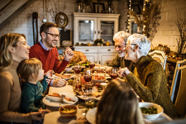 istock Happy multi-generation family communicating while having Thanksgiving lunch in dining room. 1539055146