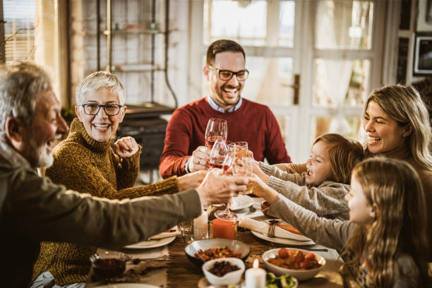istock Happy multi-generation family toasting while having lunch in dining room. 1539058531