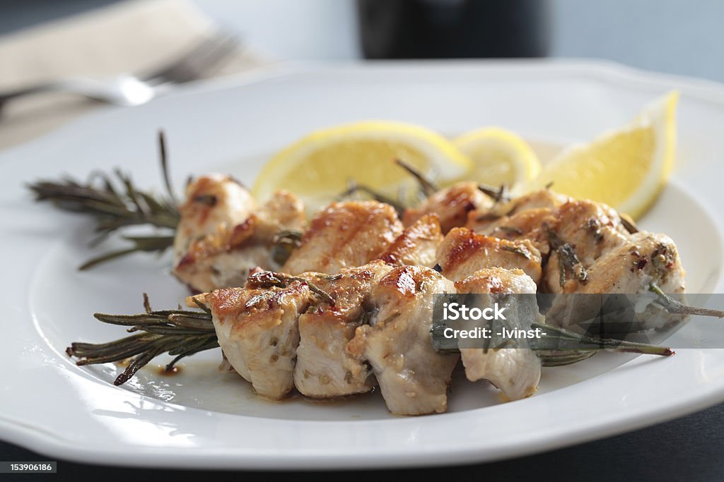 Souvlaki on rosemary sticks Chicken souvlaki on rosemary sticks with lemon Barbecue Chicken Stock Photo