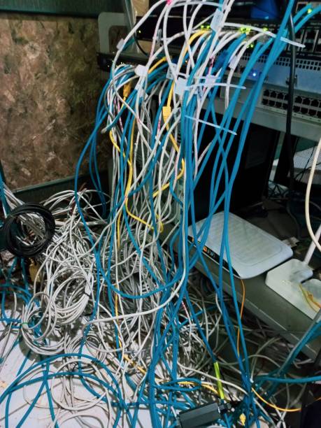 istock Switchboard panel with chaotic mess cables connections, Chaos In Server Room, The tangled network cable 1539075241