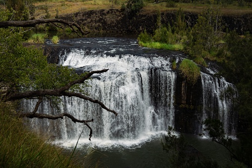 A landscape view of The Millstream Falls in Millstream Falls National Park, Australia.