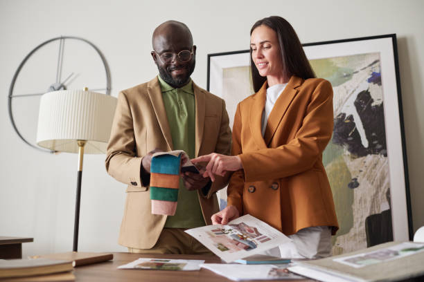 istock Two young creative designers choosing color and textile from sample collection 1539085972