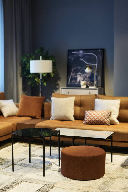 istock Two soft brown couches with cushions making corner in spacious room 1539085973