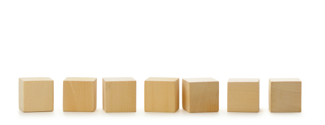 Wooden cubes in row. It is isolated on a white background
