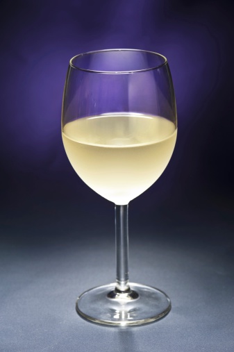 White Wine in front of beautiful purple background