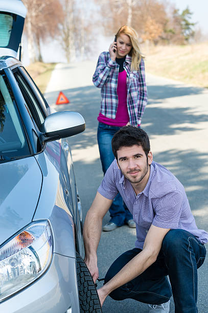 istock Car wheel defect man change puncture tire 153916982