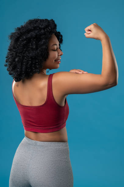 istock Athletic woman looking contented and showing her muscles 1539185260