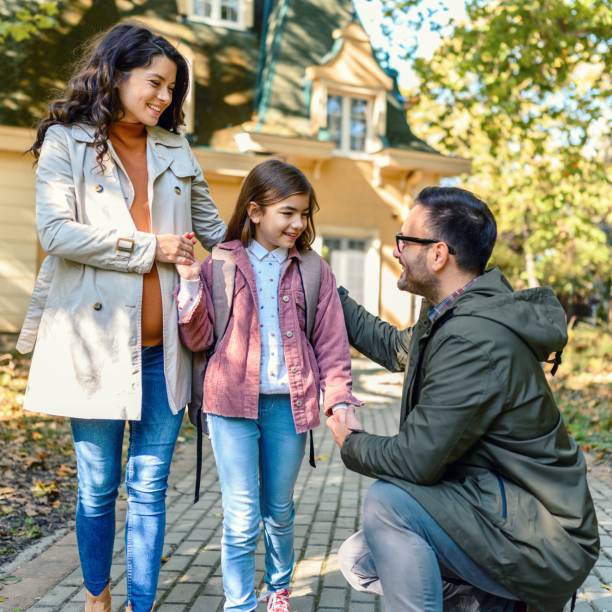 istock Mother and father taking their daughter to school 1539190498