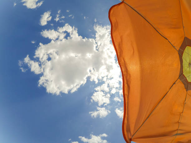 Low angle view of patio awning. colorful tightly weaved sun sail UV protection canvas fabric suspended from exterior walls. urban street in old European city. sun protection. travel and tourism concept.