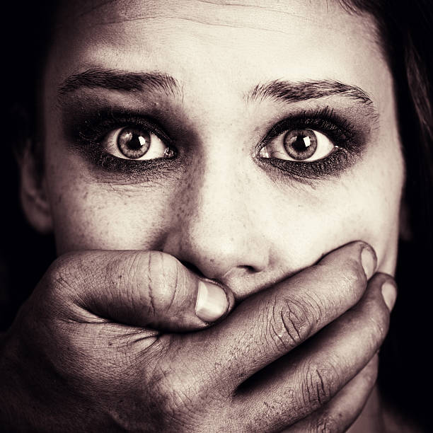 Scared woman victim of domestic torture and abuse stock photo