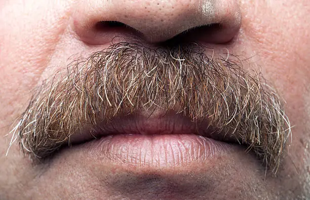 Photo of closeup mustaches and closed mouth of mature caucasian man