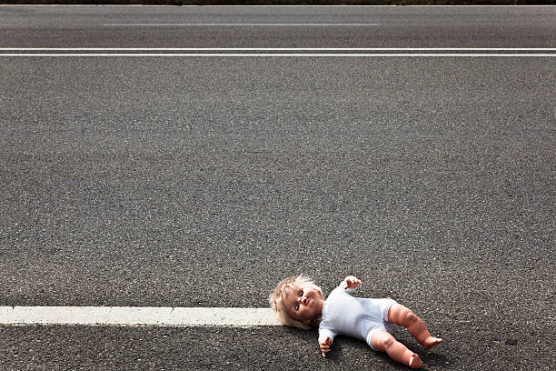 istock doll leave on a highway lane 153923016