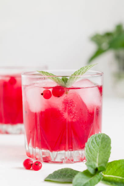 istock Cranberry cocktail with ice and mint on a white background. 1539230863