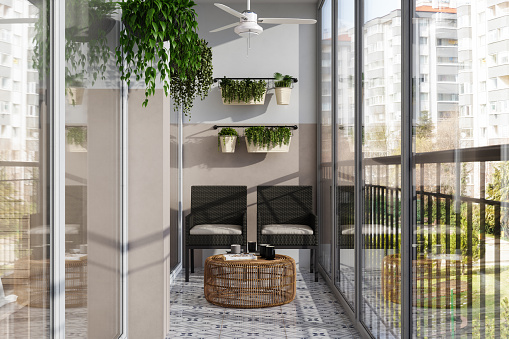 Modern Enclosed Balcony With Wicker Chairs, Coffee Table And Creeper Plants