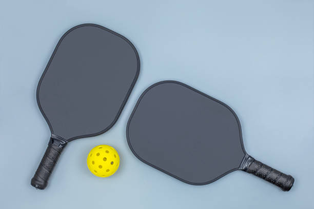istock Two pickleball paddles and ball on light gray 1539244929