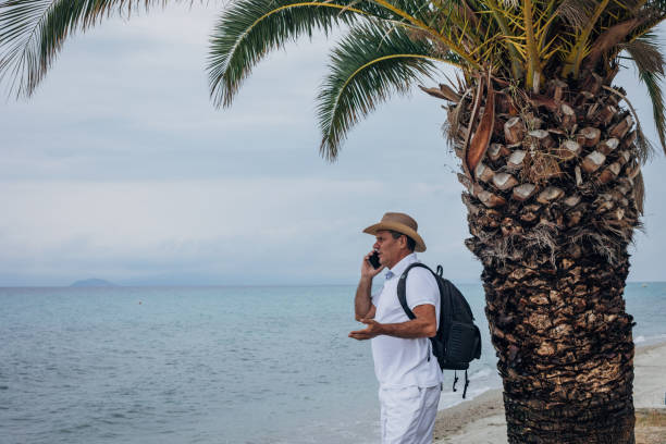 istock Old male tourist using mobile phone 1539260916