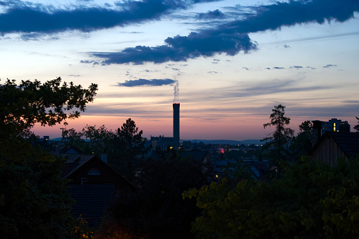 Beautiful sunset with colorful evening sky and industrial skyline at Swiss City of Zürich district Schwamendingen. Photo taken July 8th, 2023, Zurich, Switzerland.