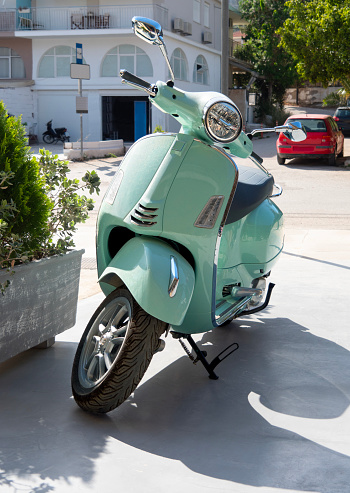 Turquoise retro scooter on Nafplion Street, Peloponnese, Greece