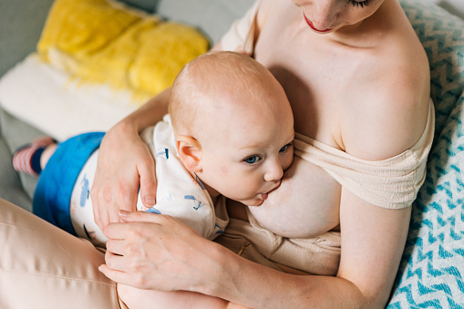 Mother breastfeeding her baby boy