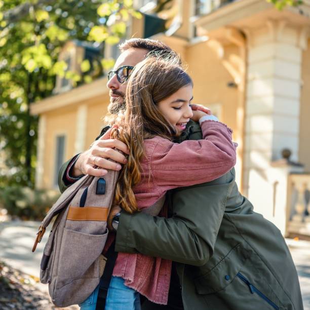 istock Daughter hugging her father after school 1539276113