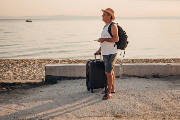 istock A tourist with a suitcase on the seashore 1539283153