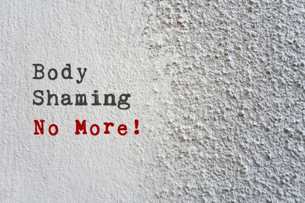 istock Grey cement concrete rough texture wall background with text BODY SHAMING NO MORE , stop humiliation about another body shape , size or criticizing appearance through negative judgment 1539336042