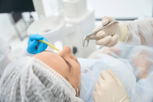 Woman in a dental chair on a tooth extraction stock photo