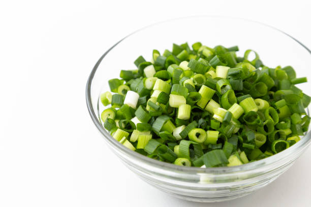 Chopped green onions on a white background.