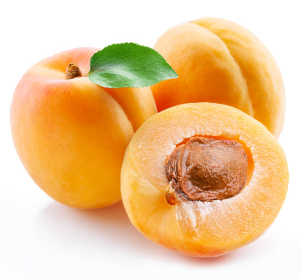 istock Ripe apricots with green leaf and apricot half isolated on white background. 1539347417
