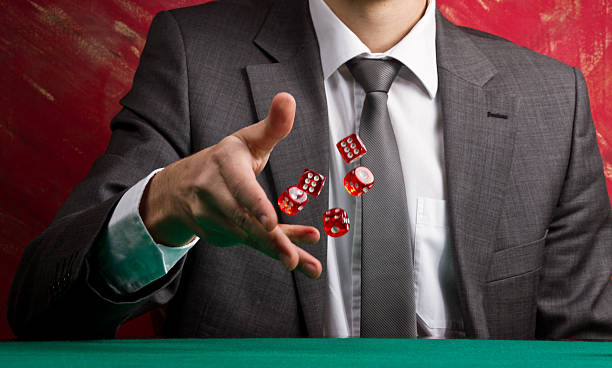 A gentleman in a suit rolling dice