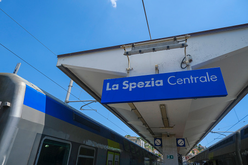 La Spezia Centrale sign on the railway station across the trains and station infrastructure