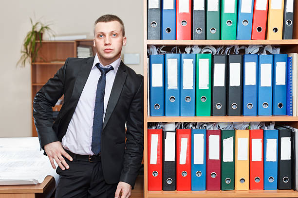 istock Young male businessman executive standing in office 153938411