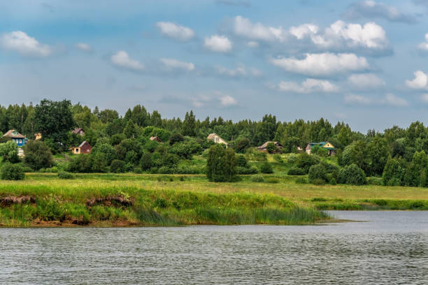 istock Rural landscape with river and village. 1539387494